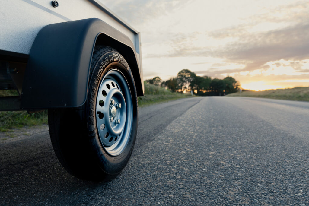 a KENDA trailer tire on a parked trailer on the roadside